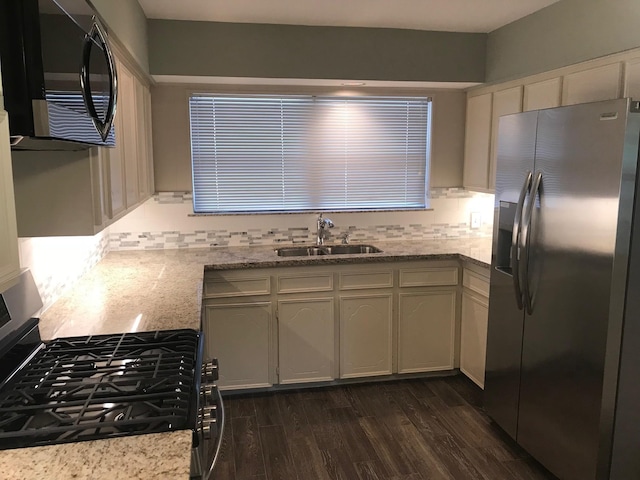 6515 Lindyann Ln, Houston, TX 77008 - kitchen featuring stainless steel appliances, backsplash, dark wood finished floors, and light stone countertops