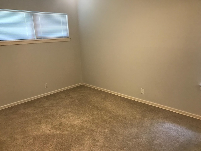 6515 Lindyann Ln, Houston, TX 77008 - empty room featuring dark colored carpet and baseboards