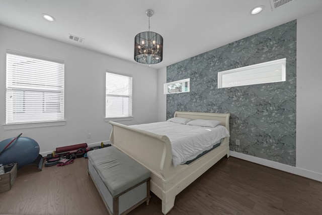 734 W Donovan St, Houston, TX 77091 - bedroom featuring wood finished floors, a chandelier, recessed lighting, wallpapered walls, and an accent wall