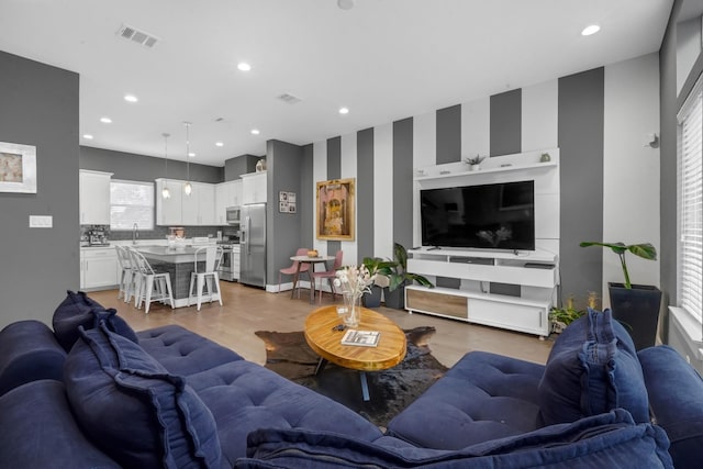 734 W Donovan St, Houston, TX 77091 - living area featuring light wood-type flooring and recessed lighting