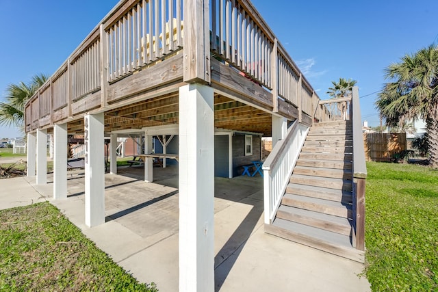 4211 Surf Dr, Galveston, TX 77554 - view of side of property featuring stairs, board and batten siding, and a wooden deck