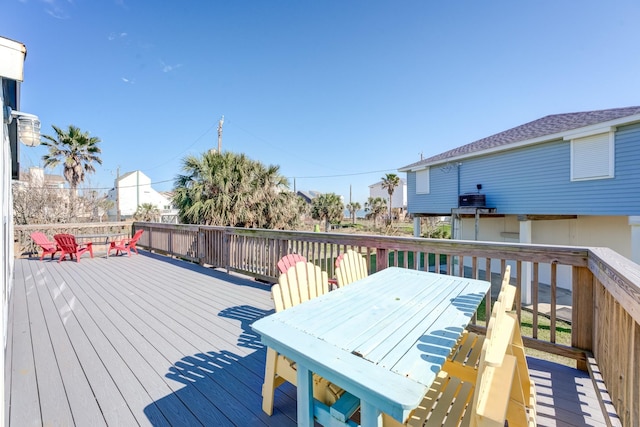 4211 Surf Dr, Galveston, TX 77554 - wooden terrace with outdoor dining space
