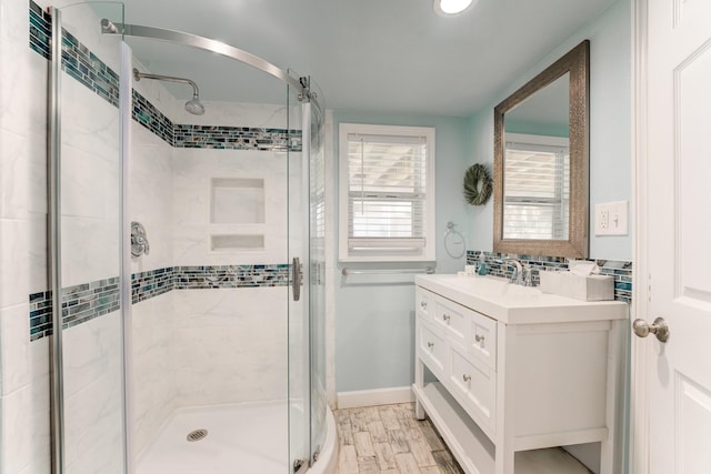 4211 Surf Dr, Galveston, TX 77554 - bathroom with a stall shower, vanity, and wood finished floors