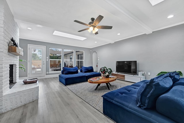 7530 Deep Forest Dr, Houston, TX 77088 - living area with a skylight, a ceiling fan, a fireplace, wood finished floors, and recessed lighting