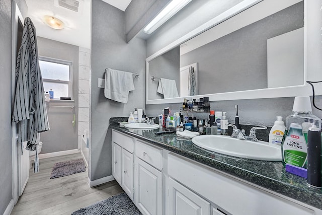 7530 Deep Forest Dr, Houston, TX 77088 - bathroom with double vanity and wood finished floors