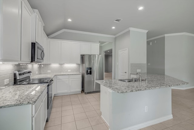 285 Rd 66121, Dayton, TX 77535 - kitchen with appliances with stainless steel finishes, light tile patterned floors, white cabinetry, decorative backsplash, and ornamental molding