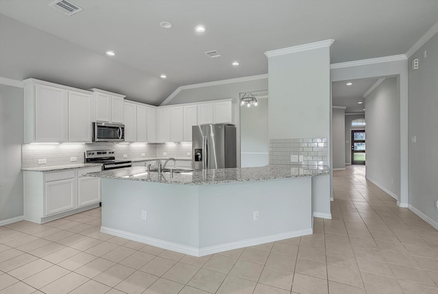 285 Rd 66121, Dayton, TX 77535 - kitchen with stainless steel appliances, backsplash, light tile patterned flooring, light stone countertops, and ornamental molding