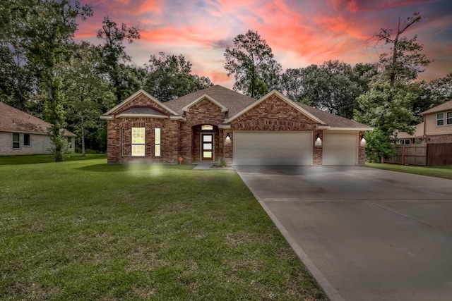 285 Rd 66121, Dayton, TX 77535 - view of front of house with brick siding, driveway, a garage, and roof with shingles