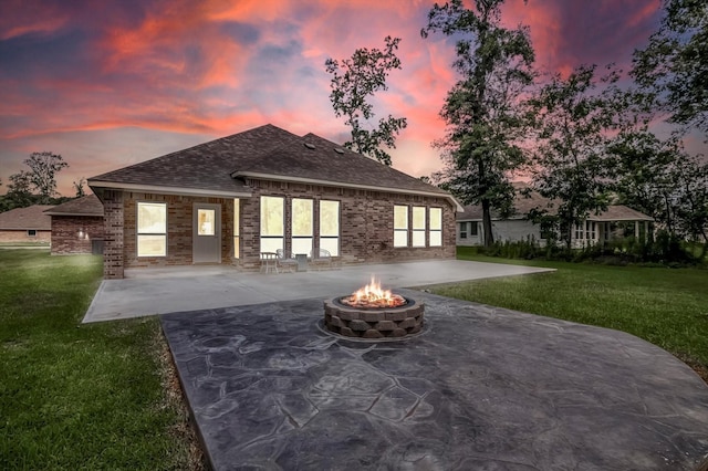 285 Rd 66121, Dayton, TX 77535 - back of house featuring a fire pit, a patio, a yard, and brick siding