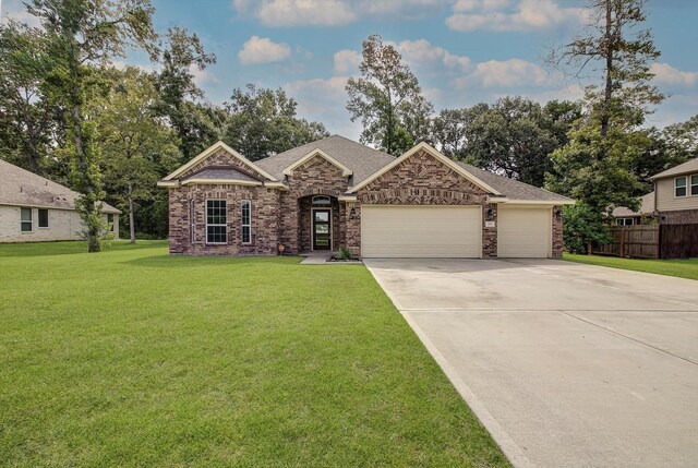 285 Rd 66121, Dayton, TX 77535 - view of front of property featuring brick siding, driveway, an attached garage, and a shingled roof