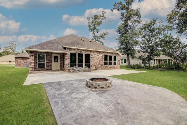 285 Rd 66121, Dayton, TX 77535 - rear view of property featuring a patio area, an outdoor fire pit, a lawn, a shingled roof, and brick siding