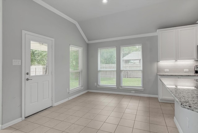 285 Rd 66121, Dayton, TX 77535 - unfurnished dining area featuring lofted ceiling, ornamental molding, and light tile patterned flooring