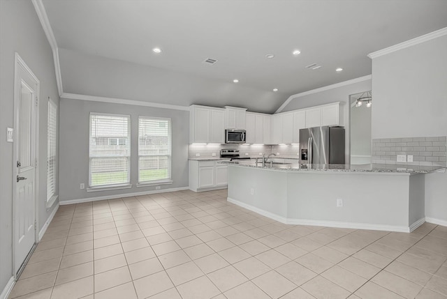 285 Rd 66121, Dayton, TX 77535 - kitchen featuring appliances with stainless steel finishes, vaulted ceiling, crown molding, tasteful backsplash, and light stone counters