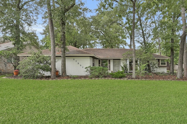 27237 Lana Ln, Conroe, TX 77385 - single story home with a front lawn and roof with shingles