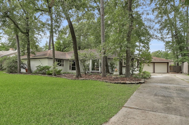 27237 Lana Ln, Conroe, TX 77385 - ranch-style home with concrete driveway and a garage