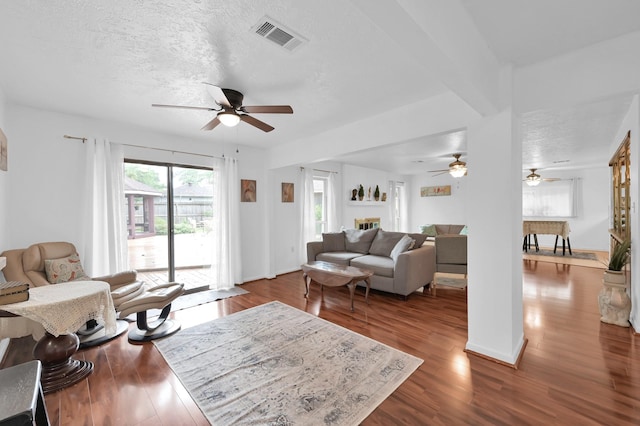 27237 Lana Ln, Conroe, TX 77385 - living room featuring ceiling fan, dark wood-style floors, and a textured ceiling