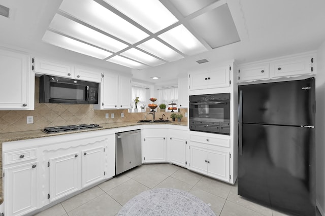 27237 Lana Ln, Conroe, TX 77385 - kitchen featuring black appliances, white cabinetry, decorative backsplash, light tile patterned flooring, and light stone counters