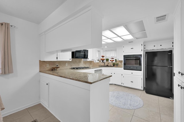 27237 Lana Ln, Conroe, TX 77385 - kitchen featuring black appliances, light tile patterned flooring, a peninsula, backsplash, and white cabinets