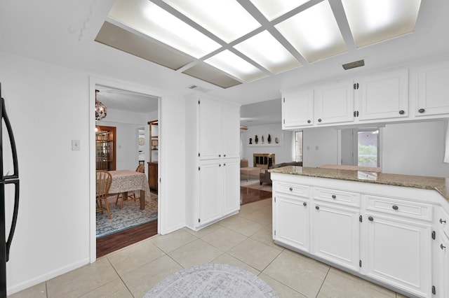 27237 Lana Ln, Conroe, TX 77385 - kitchen with light tile patterned floors, white cabinetry, and light stone counters