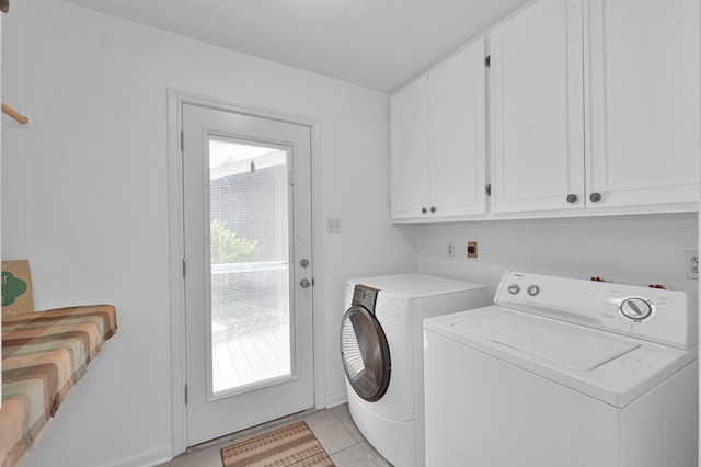 27237 Lana Ln, Conroe, TX 77385 - laundry room with cabinet space, washer and clothes dryer, and light tile patterned floors