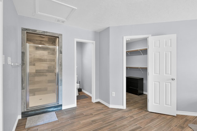 27237 Lana Ln, Conroe, TX 77385 - unfurnished bedroom with attic access, wood finished floors, and a spacious closet