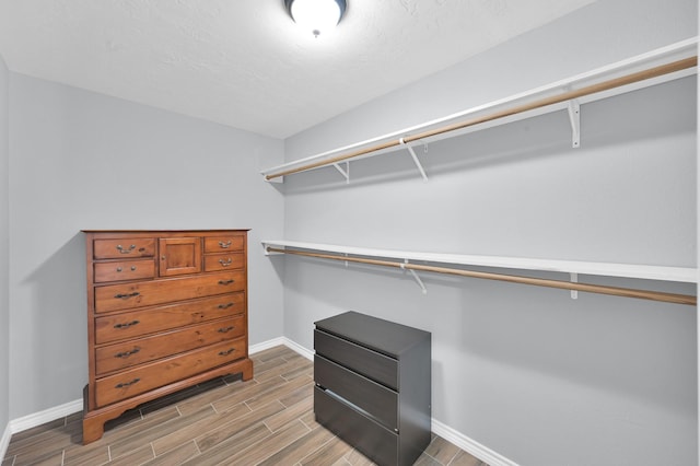 27237 Lana Ln, Conroe, TX 77385 - walk in closet featuring wood finish floors