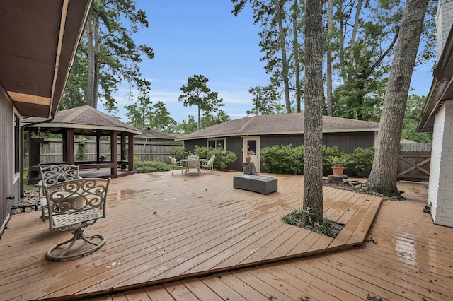 27237 Lana Ln, Conroe, TX 77385 - wooden terrace with a gazebo, outdoor dining space, and a fenced backyard