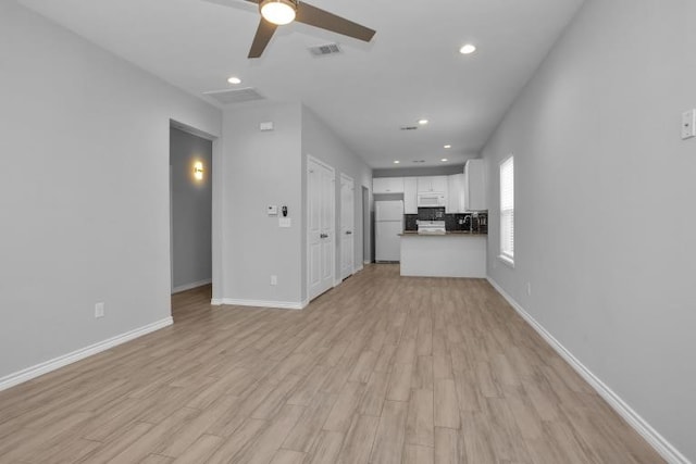 16850 Glenheath, Montgomery, TX 77316 - unfurnished living room featuring ceiling fan, light wood finished floors, and recessed lighting