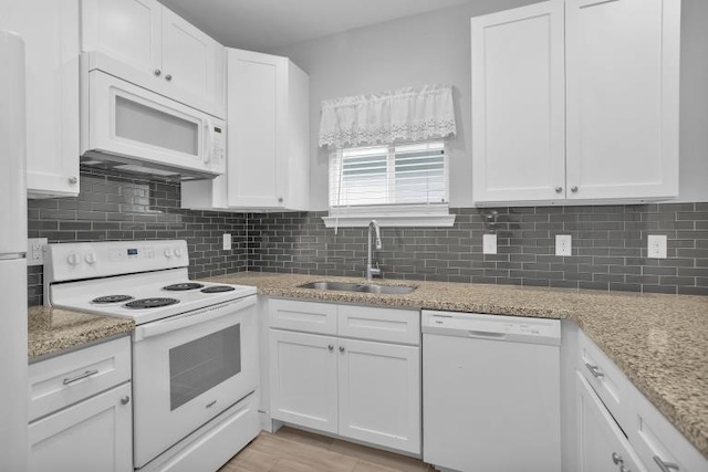 16850 Glenheath, Montgomery, TX 77316 - kitchen with white appliances, white cabinets, backsplash, and light stone countertops