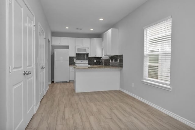 16850 Glenheath, Montgomery, TX 77316 - kitchen featuring white appliances, white cabinetry, tasteful backsplash, light wood-style flooring, and recessed lighting