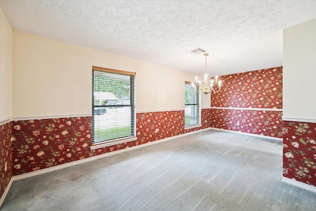 16810 Methil Dr, Spring, TX 77379 - carpeted spare room featuring wallpapered walls, a chandelier, and a textured ceiling