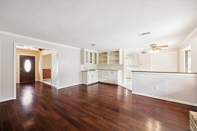 16810 Methil Dr, Spring, TX 77379 - unfurnished living room featuring ornamental molding, dark wood-style flooring, ceiling fan, and healthy amount of natural light