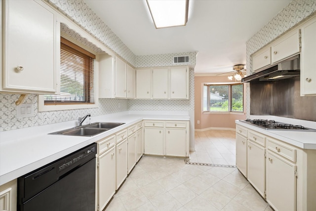 16810 Methil Dr, Spring, TX 77379 - kitchen featuring black dishwasher, under cabinet range hood, stainless steel gas stovetop, light countertops, and backsplash