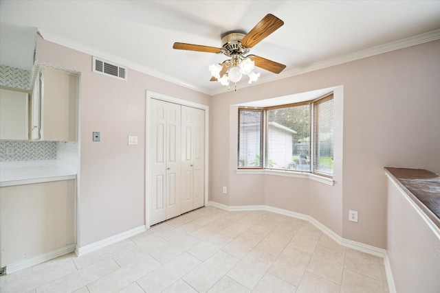 16810 Methil Dr, Spring, TX 77379 - unfurnished dining area with a ceiling fan, crown molding, and light tile patterned floors