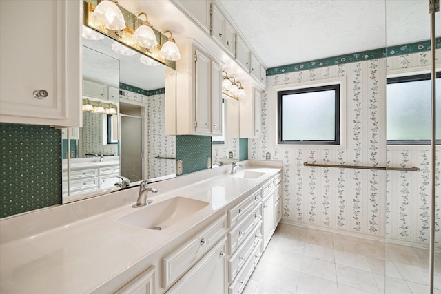 16810 Methil Dr, Spring, TX 77379 - bathroom with wallpapered walls, double vanity, and a shower stall