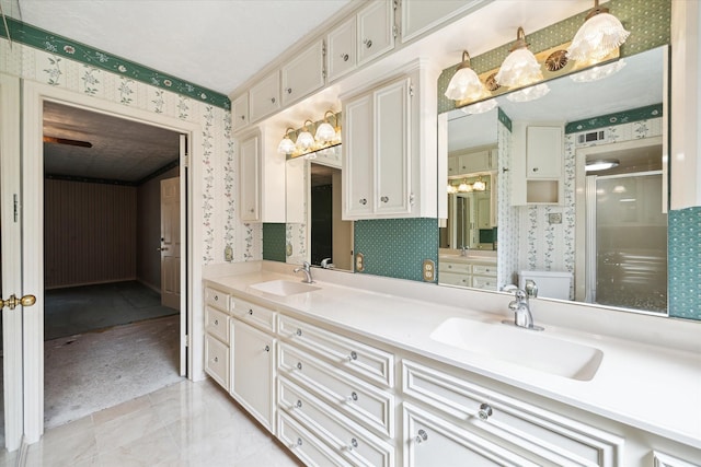 16810 Methil Dr, Spring, TX 77379 - full bathroom with wallpapered walls, double vanity, a shower stall, and marble finish floors