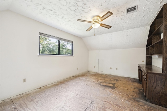 16810 Methil Dr, Spring, TX 77379 - additional living space featuring vaulted ceiling, ceiling fan, and a textured ceiling