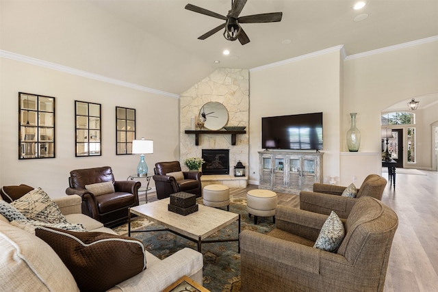 12015 Obsidian Ln, Dayton, TX 77535 - living area with a ceiling fan, wood finished floors, ornamental molding, vaulted ceiling, and a fireplace