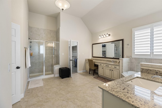12015 Obsidian Ln, Dayton, TX 77535 - full bath featuring two vanities, a stall shower, plenty of natural light, and lofted ceiling
