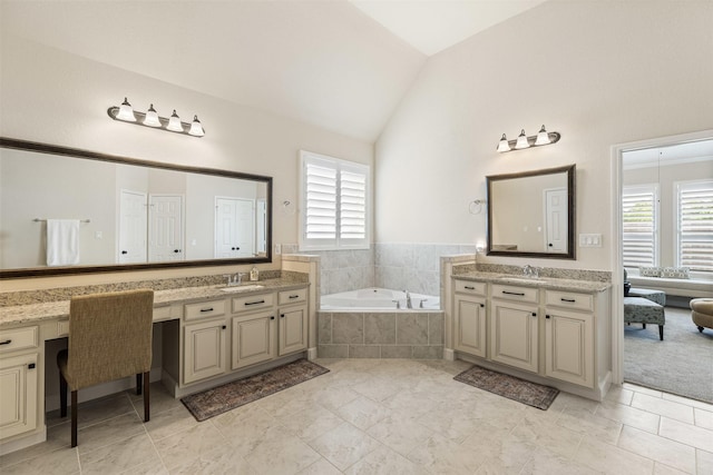 12015 Obsidian Ln, Dayton, TX 77535 - full bathroom featuring healthy amount of natural light, a garden tub, two vanities, and vaulted ceiling