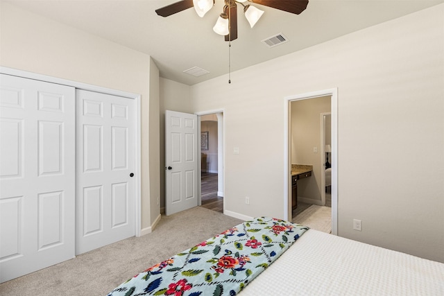 12015 Obsidian Ln, Dayton, TX 77535 - bedroom with light carpet, a closet, connected bathroom, and a ceiling fan