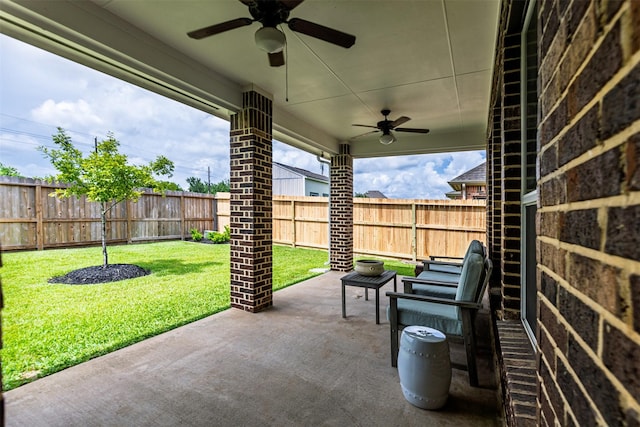 12015 Obsidian Ln, Dayton, TX 77535 - fenced backyard featuring a ceiling fan and a patio area
