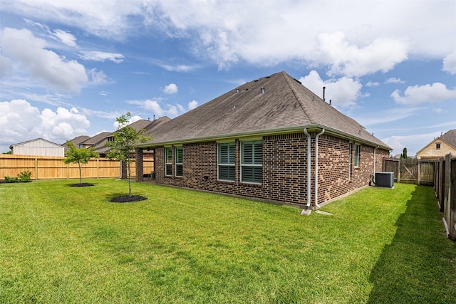 12015 Obsidian Ln, Dayton, TX 77535 - rear view of property featuring brick siding, a fenced backyard, and roof with shingles