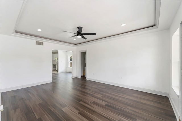 102 Glendale St, Houston, TX 77012 - empty room with a ceiling fan, recessed lighting, dark wood-type flooring, and a raised ceiling