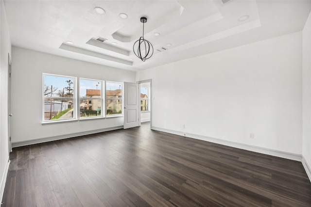 102 Glendale St, Houston, TX 77012 - empty room featuring a raised ceiling, dark wood-style flooring, and recessed lighting