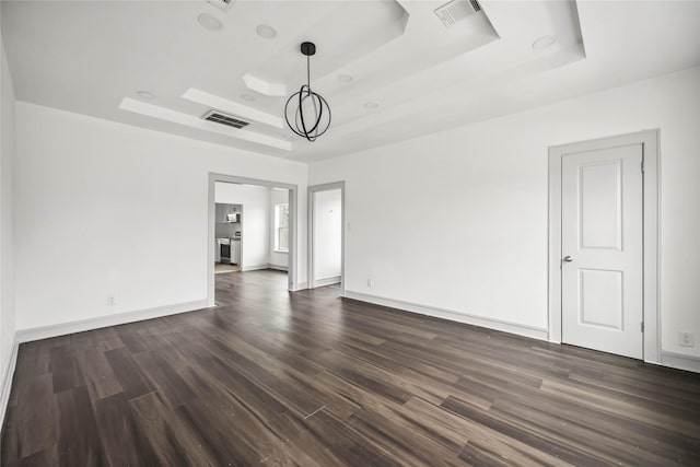 102 Glendale St, Houston, TX 77012 - spare room featuring a raised ceiling, dark wood finished floors, and a chandelier