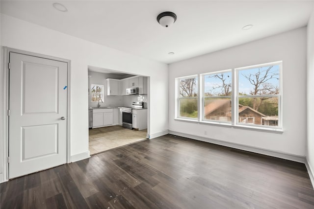 102 Glendale St, Houston, TX 77012 - unfurnished living room with plenty of natural light and dark wood-style flooring