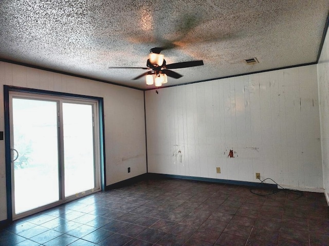 505 Allen Ct, Alvin, TX 77511 - spare room with ceiling fan, wood walls, and a textured ceiling