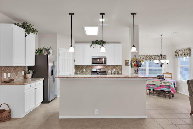 30302 Castle Forest Dr, Spring, TX 77386 - kitchen with appliances with stainless steel finishes, tasteful backsplash, light tile patterned floors, and white cabinetry