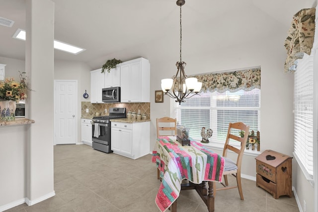 30302 Castle Forest Dr, Spring, TX 77386 - dining space featuring a chandelier, light tile patterned floors, and lofted ceiling